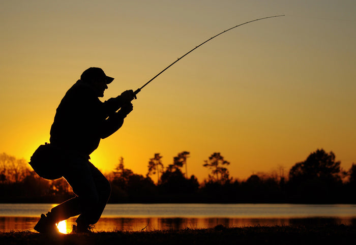 Man Fishing at Front of Boat